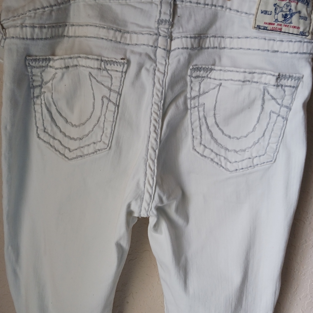 True Religion White jeans with grey stitching.